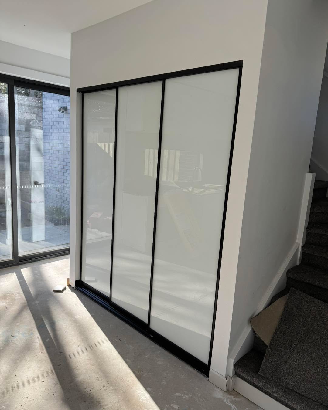 Modern bathroom with black-framed sliding shower enclosure
